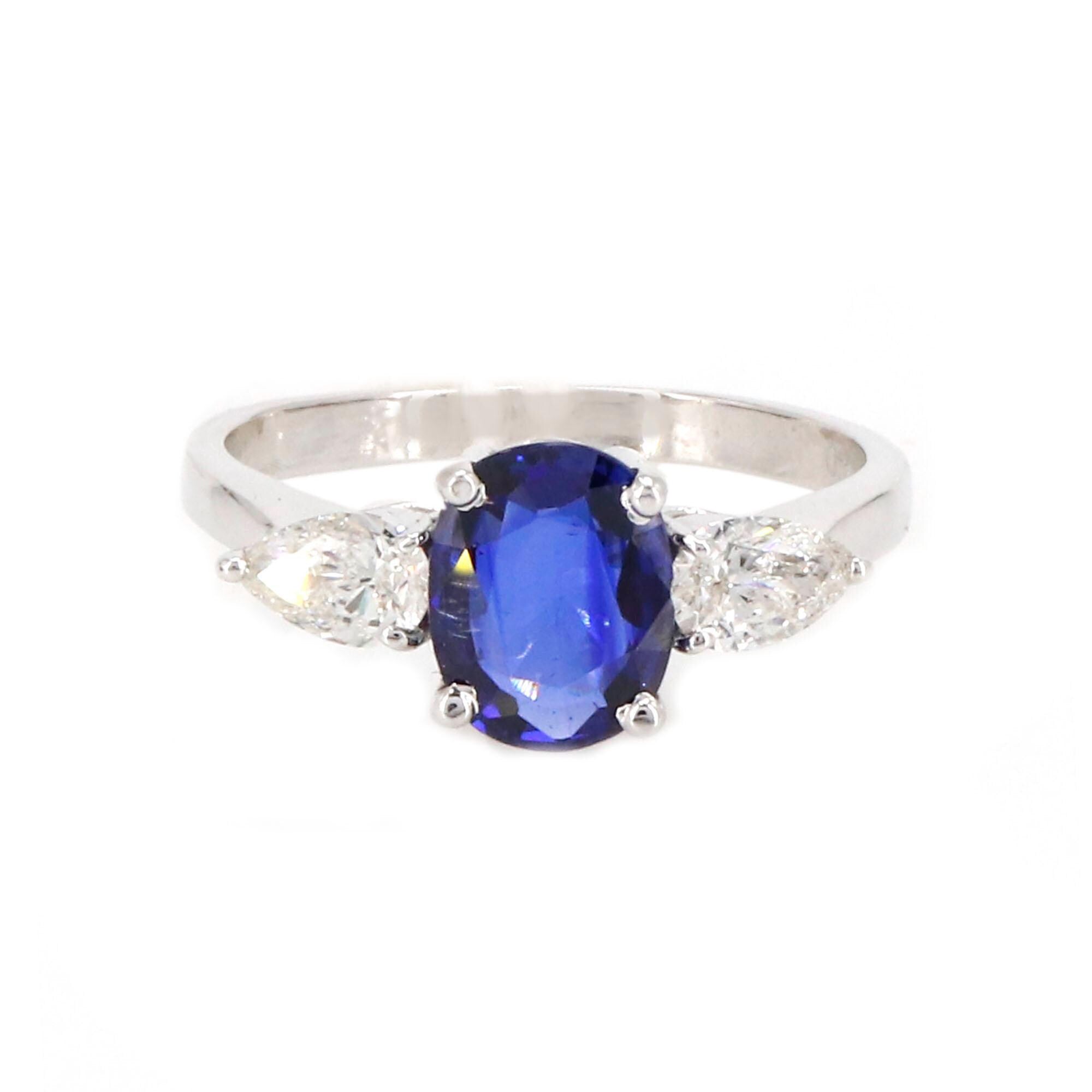 A Vibrant Oval Cut Sapphire At The Center Flanked By Brilliant Pear Cut This Ring 18K Gold
